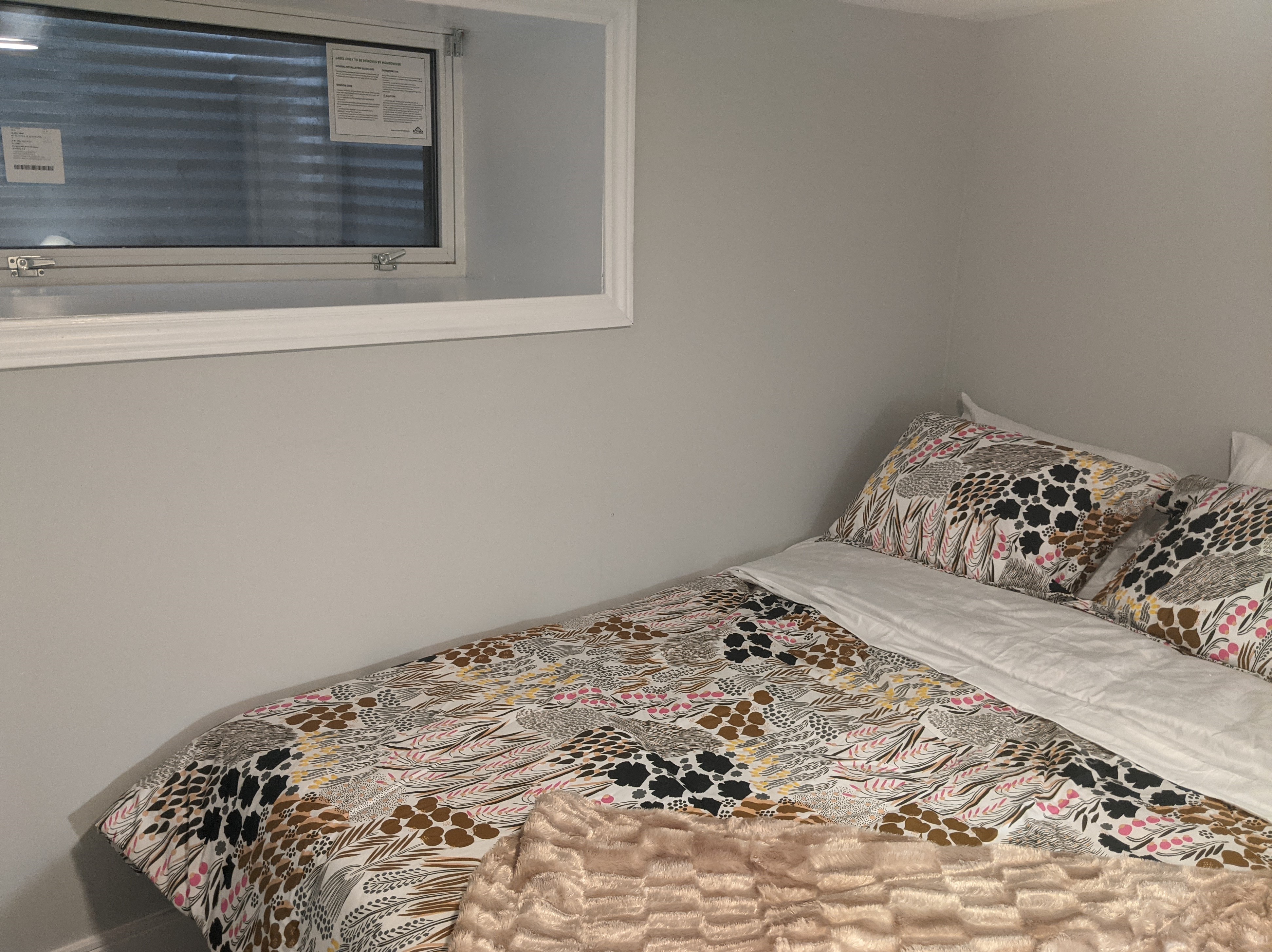 a small bedroom with a bed and a window